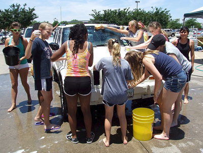 Image: The Italy Jr. High and High School Cheerleaders have fun soaping and washing vehicles for a few extra dollars next to Lowe’s in Waxahachie.