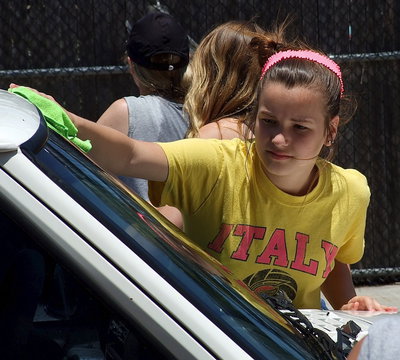 Image: IHS Cheerleader, Paige Little, takes care of the windshield.