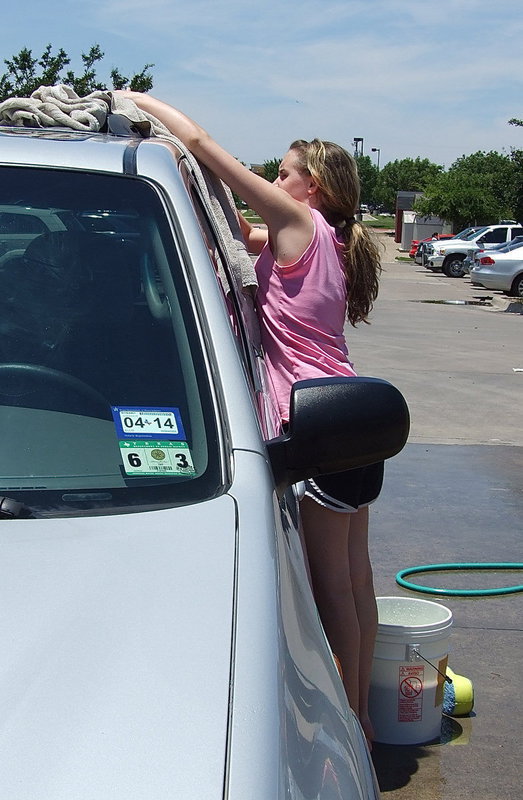 Image: IHS Cheerleader, Kirby Nelson, dries off the last few drops.