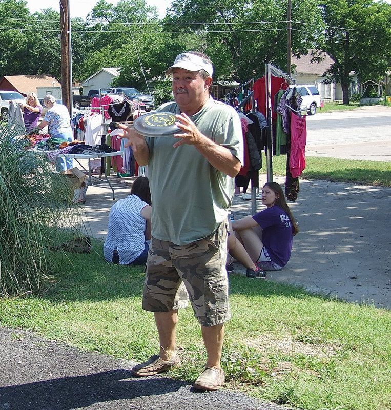 Image: Larry Eubank plays frisbee between sales.