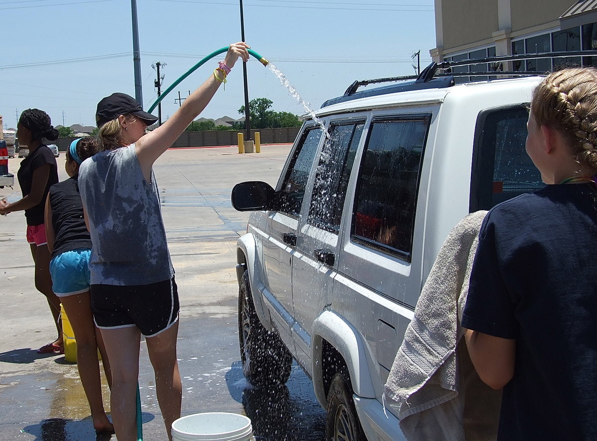 Image: Kelsey Nelson, washes away the dirt to get some shiny coin for Italy’s cheerleaders.