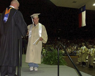 Image: Principal Lee Joffre congratulates2013 Italy High School graduate Blake Vega after Vega accepted his diploma while receiving a rousing applause from the entire Coliseum.