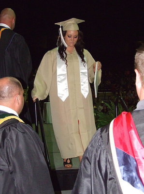 Image: 2013 Italy High School graduate Breyanna Beets takes her final steps after receiving her diploma.