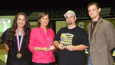 Image: Alyssa Richards and Chase Hamilton present Italy Neotribune Editor Kelly Lewis and Sports Writer Barry Byers with Texas shaped trophies of appreciation for being the team behind the teams.