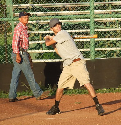 Image: Catcher Sal Perales watches as his grandson Brandon Jacinto takes aim at a pitch.