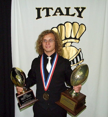 Image: Shad Newman hoists two of Italy Football’s main accomplishments in 2012.