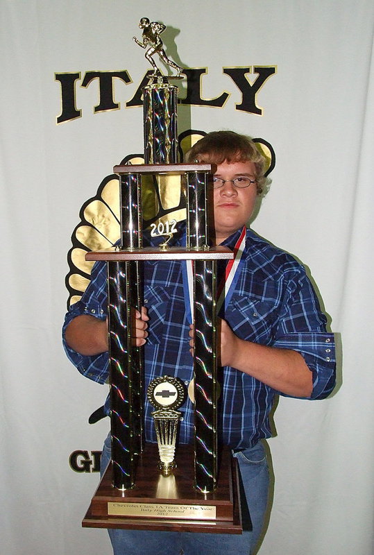 Image: Colin Newman proudly displays the North Texas Chevy 1A Team of the Year trophy presented to the Gladiator Football team during the banquet.