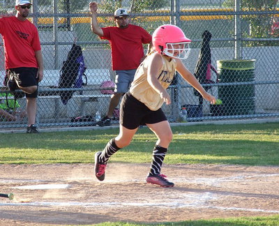 Image: Italy’s, Kiara Bueno hits the ball hard and then heads for first base.