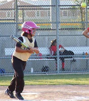 Image: The fearless Evie South pops the ball into play for a base hit.