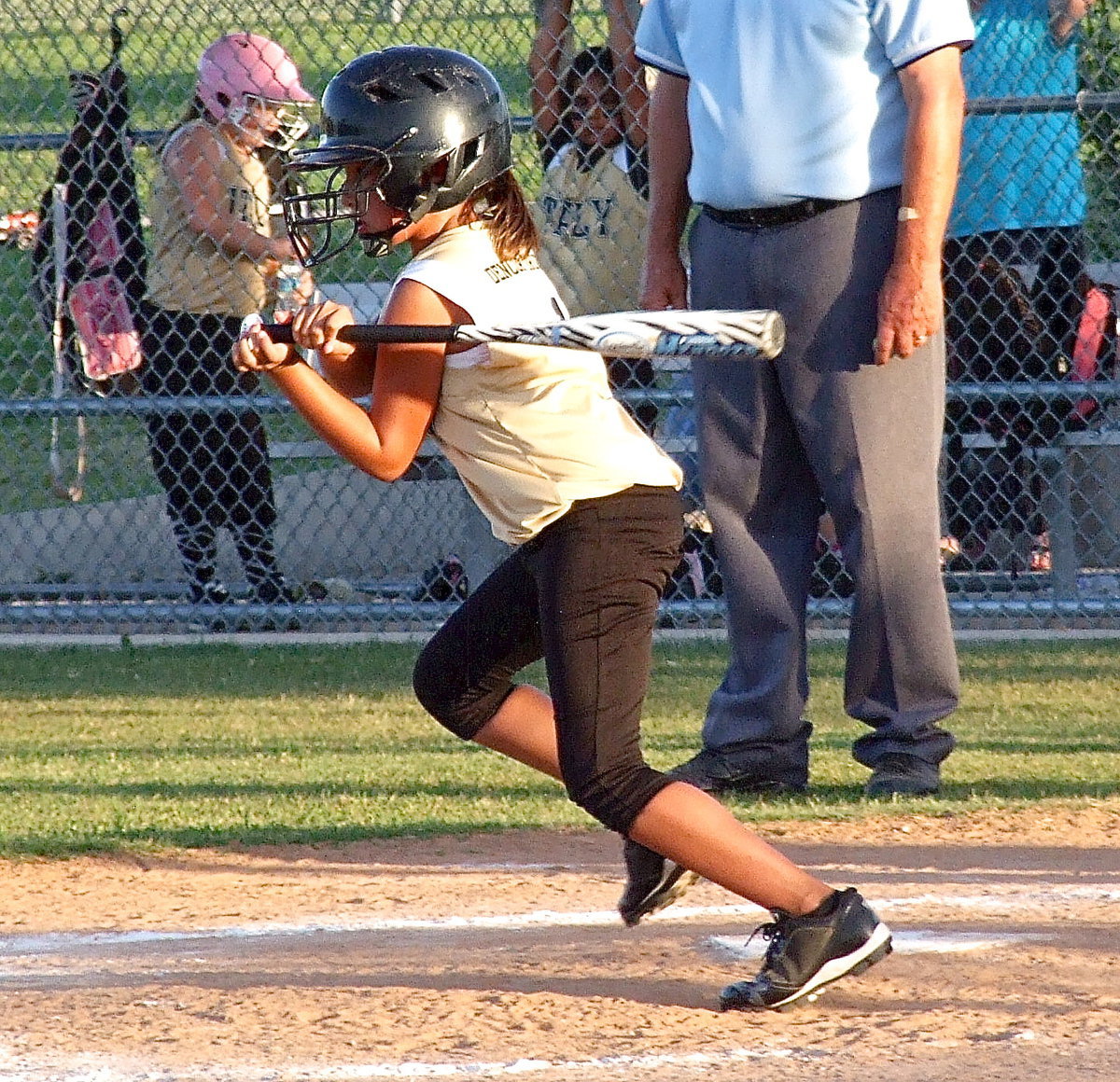 Image: Cadence Ellis gets a hit and then speeds down to first base.