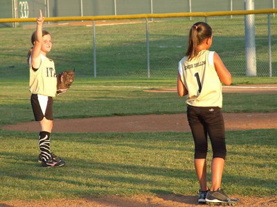 Image: Italy shortstop, Kinley Cate makes sure her teammates know their is two outs to go.