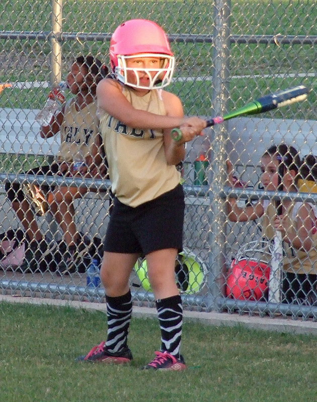 Image: Kiara Bueno has an intense look as the sun sets before giving ground to the field lights.