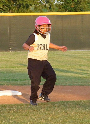 Image: Evie South wants to steal third base but is careful not to get tagged out.