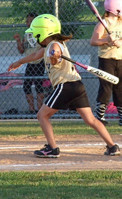 Image: Ella Hudson hits and then hurries to first base.