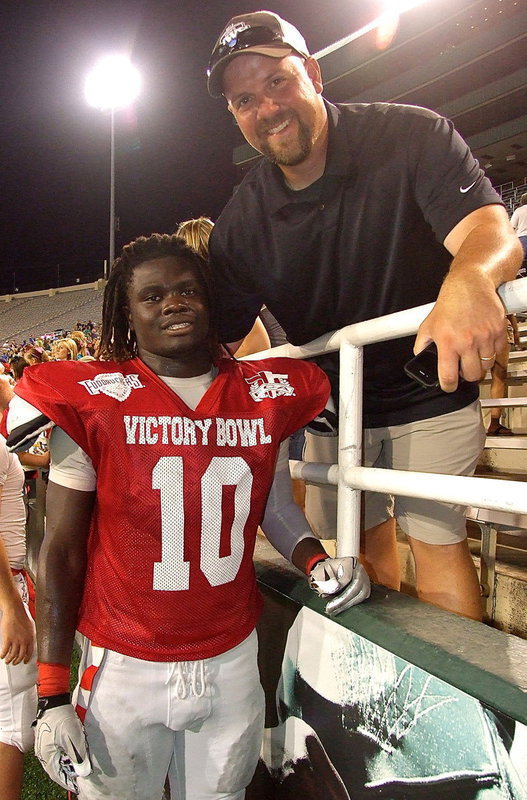 Image: Italy Athletic Director/Head Football Coach, Hank Hollywood congratulates Ryheem Walker after his performance during the 5th Annual 2013 FCA Super Centex Victory Bowl. Walker was a key weapon for Hollywood and the Italy Gladiators this past season with Italy reaching the Class A State Semifinals in 2012. “Ryheem is the fastest linebacker I have ever coached. His ability to flow side-to-side across the field is special,” Hollywood said of his Walker after the game.