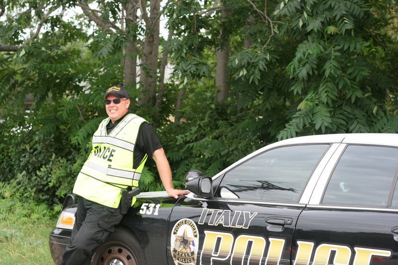 Image: Chief Diron Hill helps with traffic—bicycle and car.