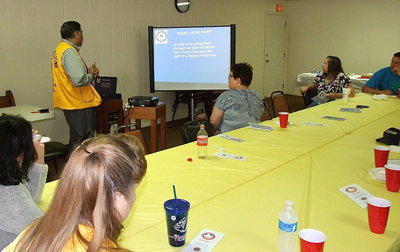 Image: Members and invited guests enjoy a slide presentation from the Dallas Filipino Lion’s Chapter and Director of Texas Lions Camp, Vinod Mathur, detailing the Texas Lion’s Camp and the function of Lion’s Club members in general.