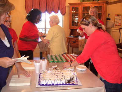 Image: Sarah Zambrano (asistant activities director) happily serving up cake to the well deserved certified aides.