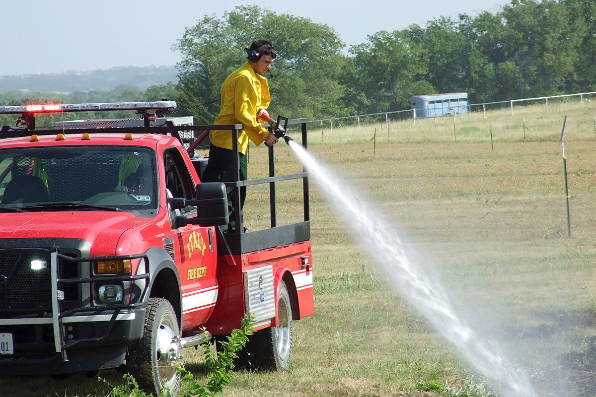 Image: Italy firefighter Brandon Jacinto begins to douse the area.