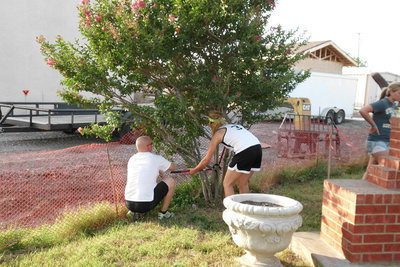 Image: Youth Minister, Michael Chambers and his daughter, Brittany, prune a crepe myrtle tree in the memorial park.
