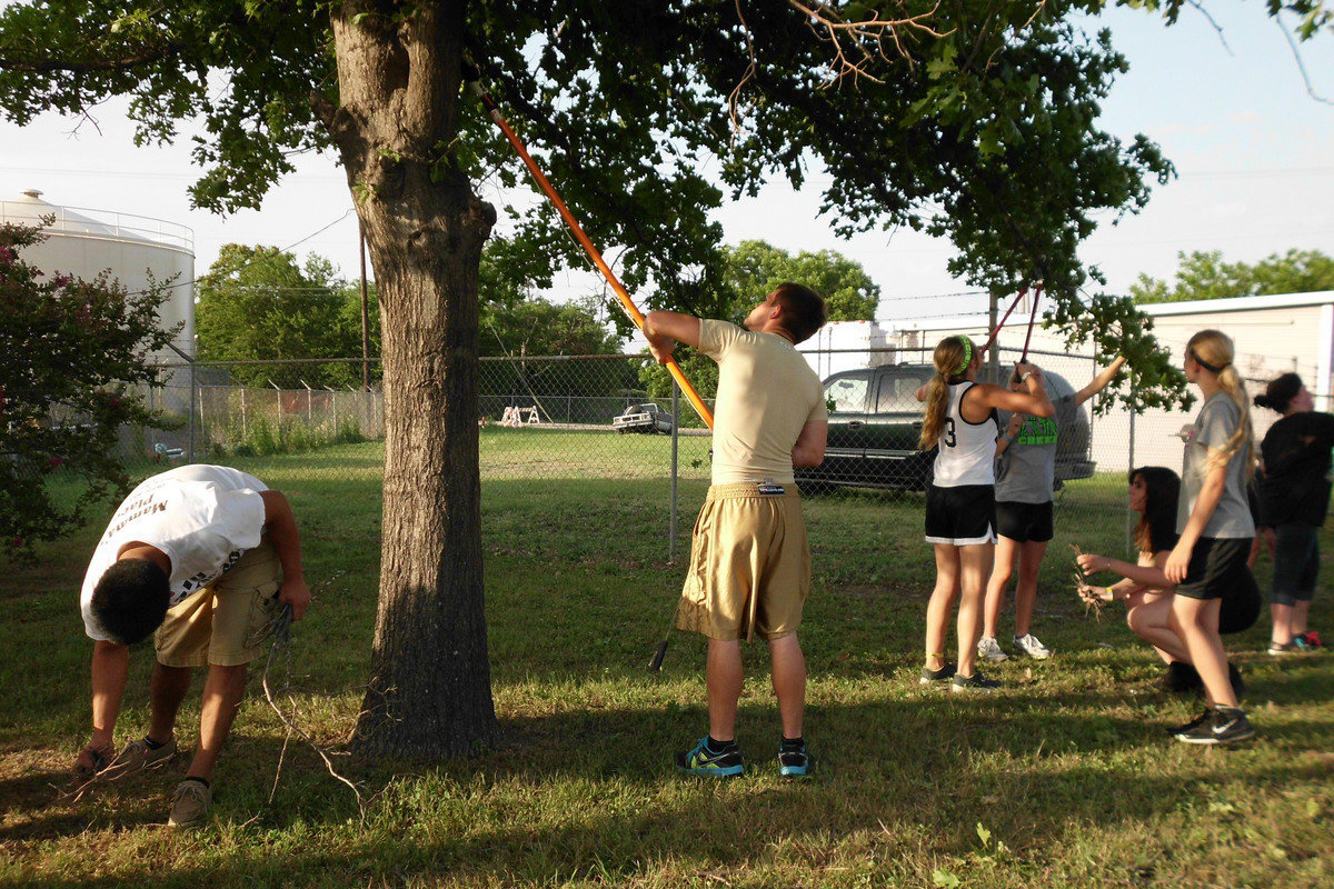 Image: Chase Hamilton and Omar Estrada trim low lying limbs.