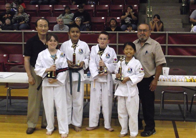 Image: Pictured are Grand Master Park-Houston, Kathryn Drennan-Grandview, Luis Rodriguez-Hillsboro, Michael Russell-Italy, Seo Young Ha-Grandview and Chief Instructor of the Hillsboro TKD School Master Charles Kight as each student receives Best Performance in there division trophies after passing a recent belt test at the Hillsboro Unified Tae Kwon Do School.