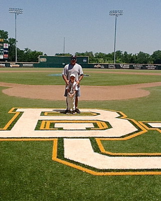 Image: Austin Cate poses with his dad, Jackie Cate, atop the Baylor University logo.