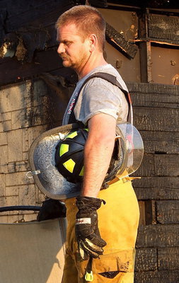 Image: Forreston firefighter, Daniel Ballard, pauses for some fresh air.