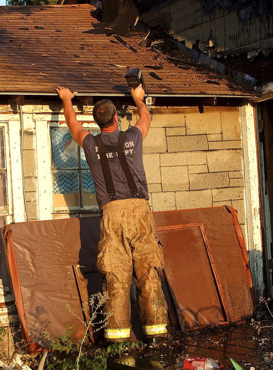 Image: Forreston firefighter, Bobby McBride, uses a thermal imaging camera to record the damage.