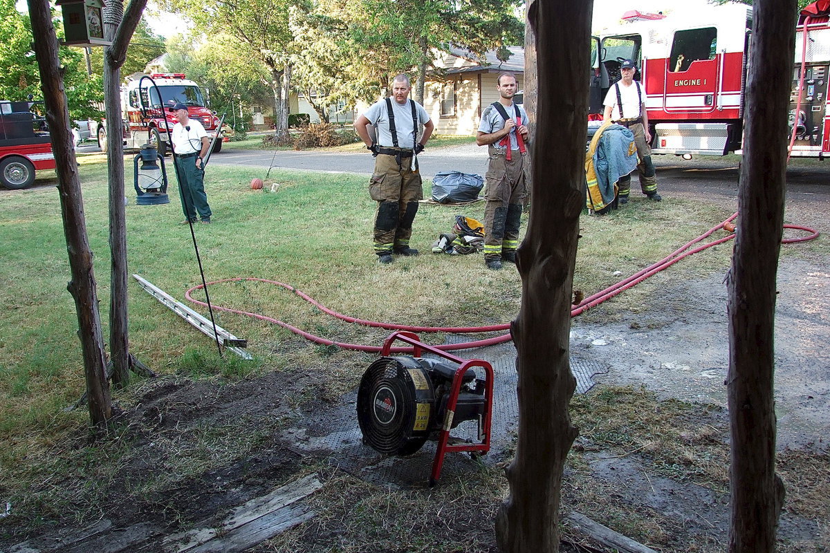 Image: A fan is used to clear smoke from the home’s interior.