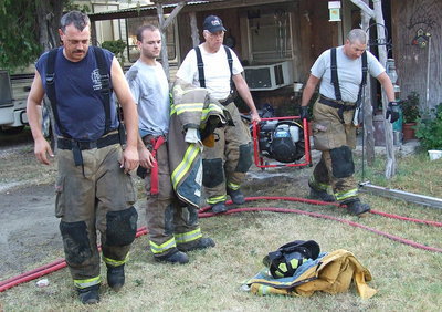Image: Forreston firefighters remove the fan as they prepare to head back to their fire station.