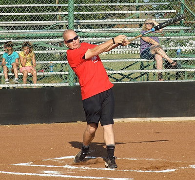 Image: Lady Gladiator assistant softball coach, Michael Chambers, swings for the pasture during the homerun derby.