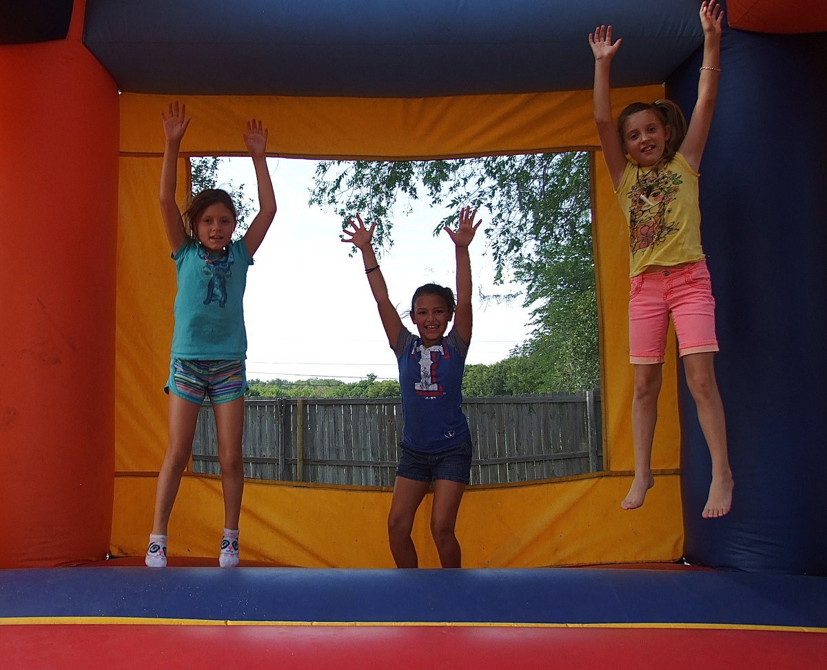 Image: Kids enjoy the bounce house as part of the festivities surrounding the 2nd Annual Guns vs. Hoses Softball Game between the Italy Police Department and the Italy Fire Department to help raise money for the Italy P.D.’s  charitable Shop with a Cop program.