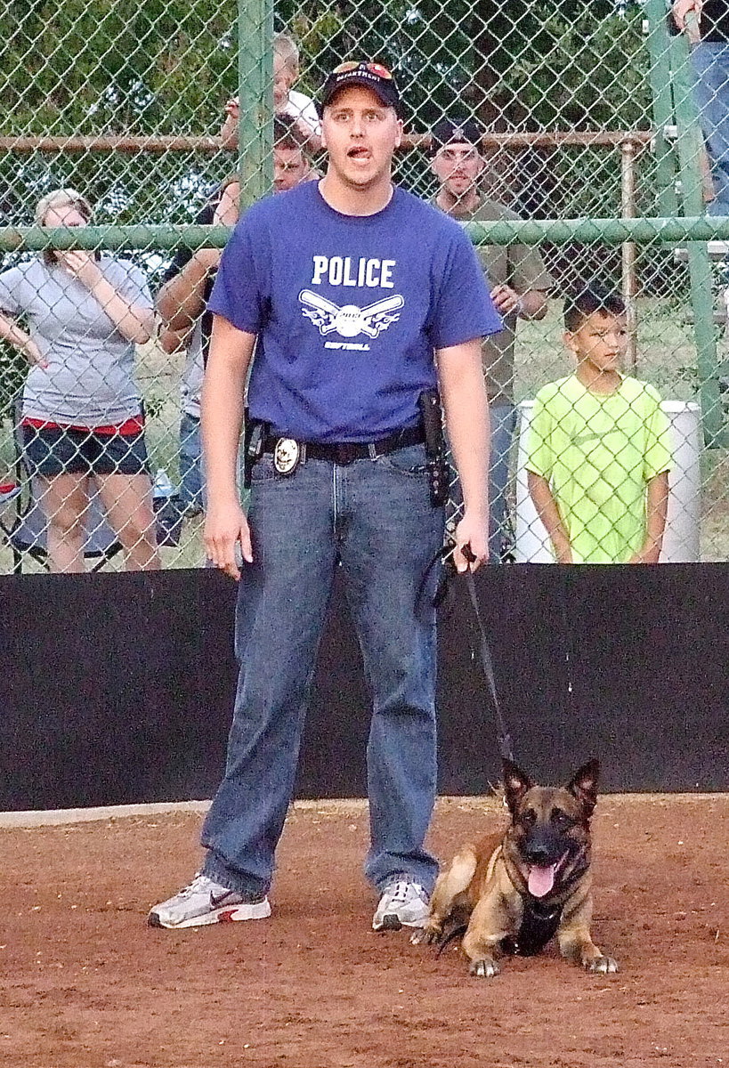 Image: Officer Michael Richardson stands with Officer Kilo by his side who is ready for the command to, “Sick ’em!”