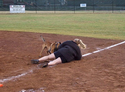Image: Officer, Kilo, takes down fellow officer, Shelbee Landon, during a demonstration down the first base line.