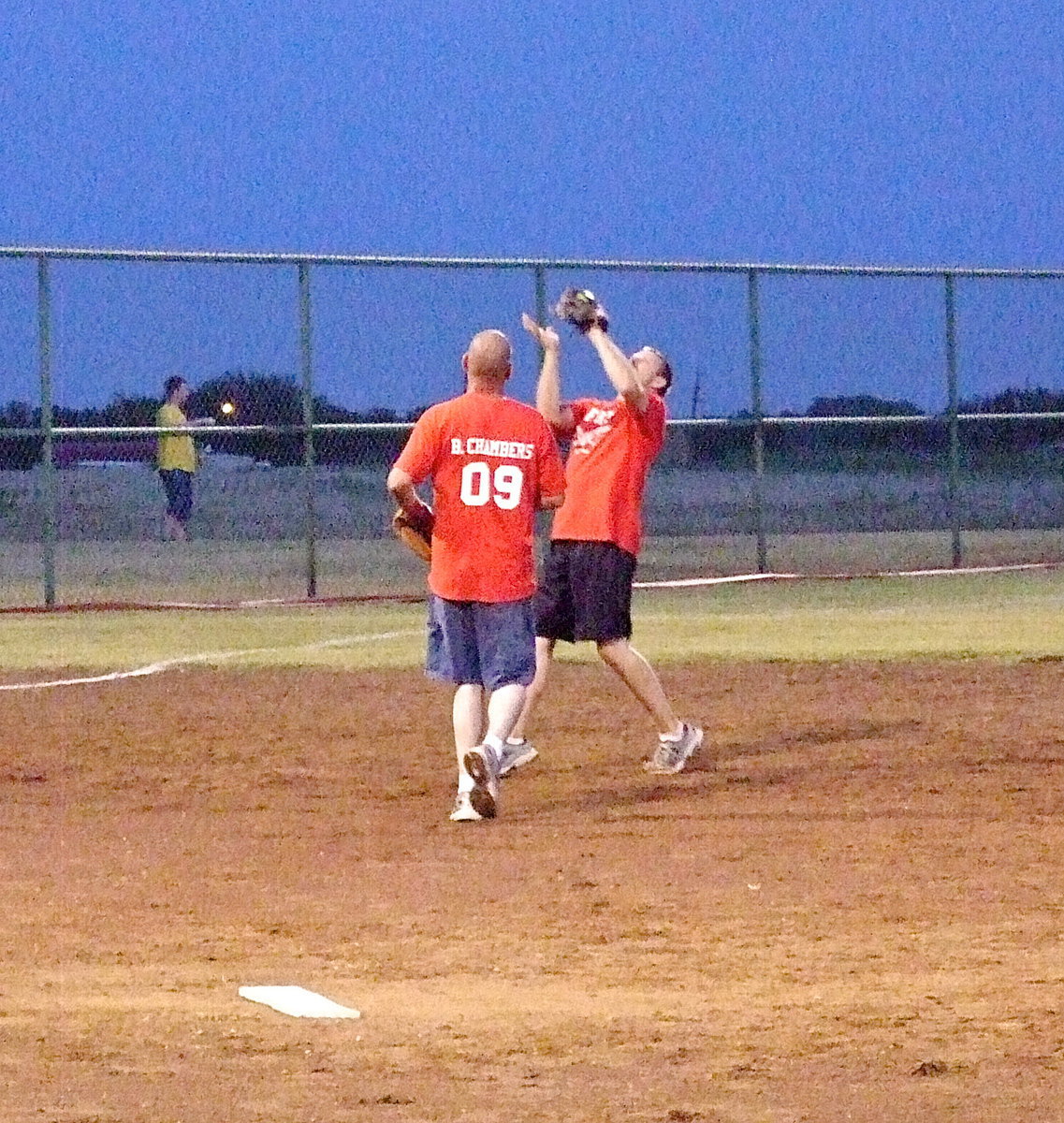 Image: Third baseman Daniel Ballard catches a pop-up for an out as pitcher Brad Chambers puts pressure on his own teammate.