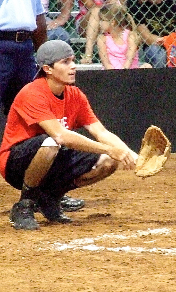 Image: Playing catcher for the Italy Fire Department is catcher and firefighter, Brandon Jacinto.