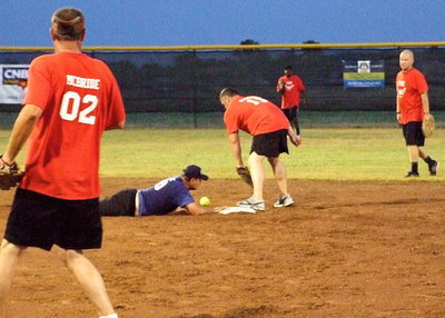 Image: Milford Police Chief Carlos Phoenix makes it safely back to second base after almost being caught during an extremely slow rundown.