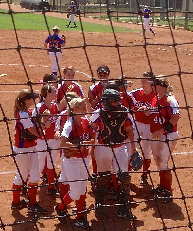 Image: Red All-Star catcher Alyssa Richards breaks the huddle with her team.
