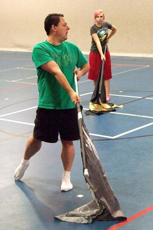 Image: Scooter Spicer out of Garland ISD arrives to demonstrate the intricacies of handling the flags for the Italy HS Color Guard during a week long camp held inside the Stafford Elementary gym.