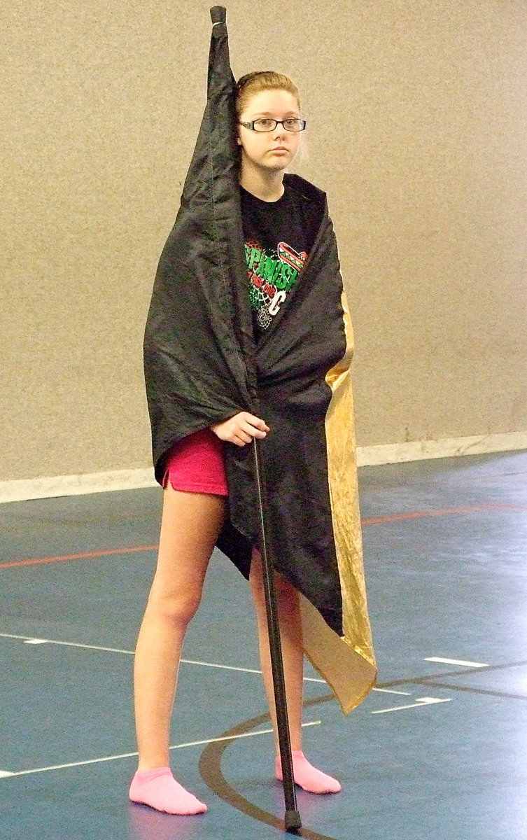 Image: IHS Color Guard captain Anna Riddle finds wears her flag like a Gladiator cape.