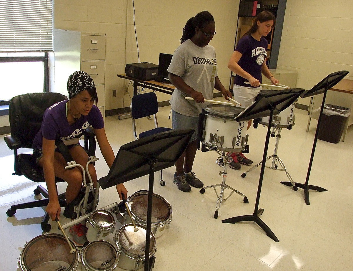Image: Brenya Williams and Whitney Wolaver help makeup the snare division of the band, along with Jarvis Harris (not pictured), while Alex Minton plays tenor.