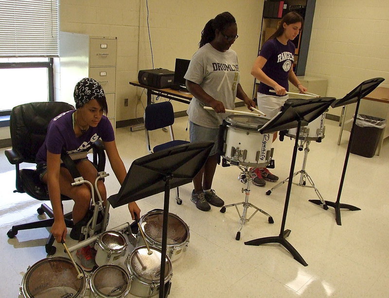 Image: Brenya Williams and Whitney Wolaver help makeup the snare division of the band, along with Jarvis Harris (not pictured), while Alex Minton plays tenor.
