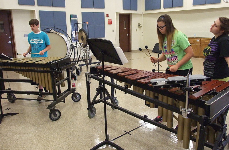 Image: Jacob “Stanley” Brooks on vibraphone and Reagan Adams on marimba get assistance from Alexia Turner, a percussionist from Baylor University.