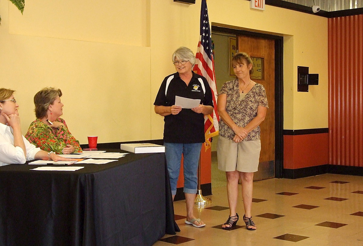 Image: Italy ISD school board member, Cheryl Owen, recaps memories and accomplishments covering 38 years in the teaching field, Margie Davis, who was officially retired by the board Monday night. Many current and past teachers and administrators were on hand to show their appreciation to Mrs. Davis for her dedication to the school and to the students.