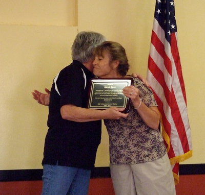 Image: Italy ISD school board member, Cheryl Owen, presents, Mrs. Margie Davis, with a plaque and a hug in recognition of her service to the district during a retirement ceremony held in the honor of Mrs. Davis.
