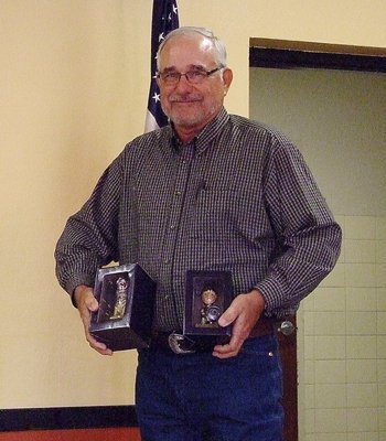 Image: Finally! Speed Hamby proudly displays his Tiger and Gladiator bobbleheads  presented to him as retirement gifts by the Italy ISD school board.