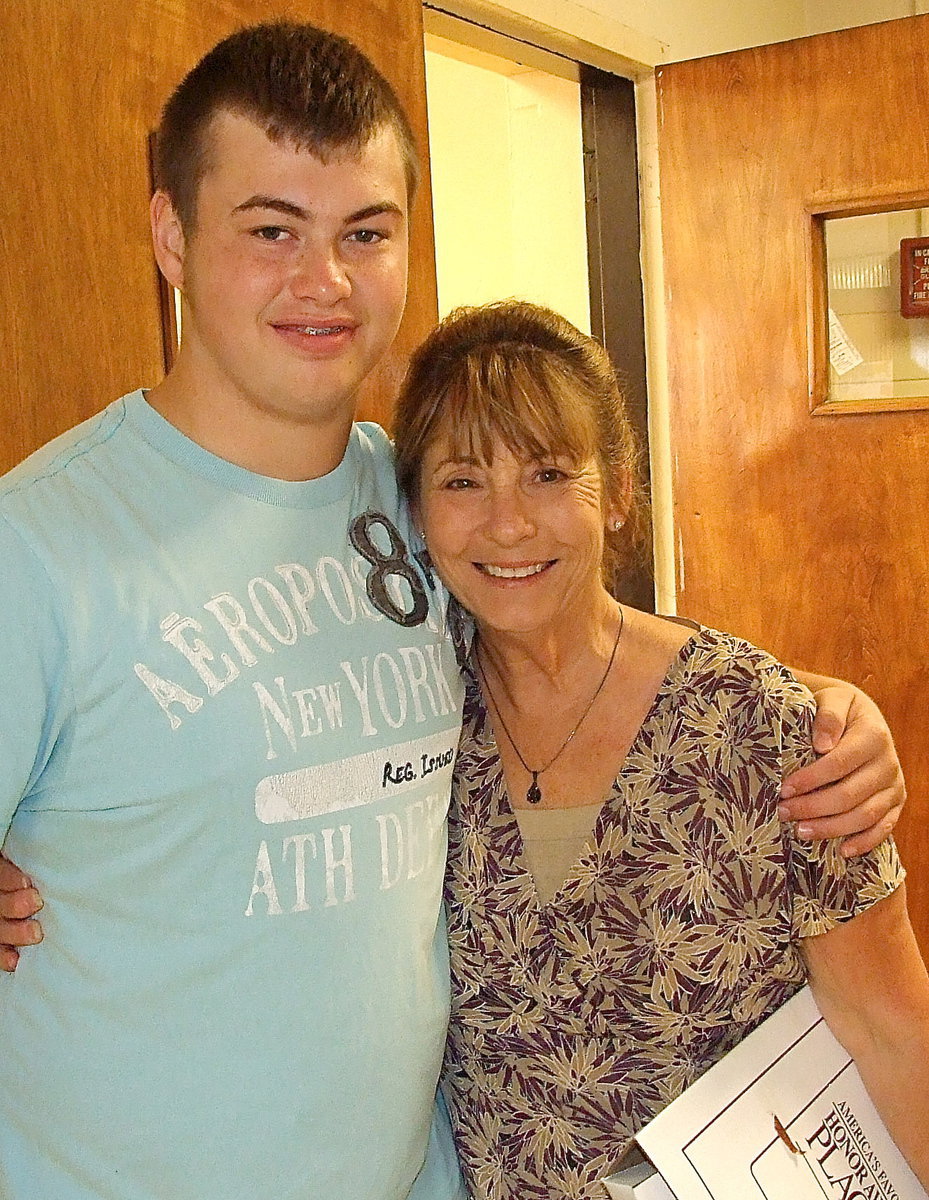 Image: Mrs. Margie Davis is congratulated for her service to the students and for her guidance to National Honor Society members by NHS Historian, Zain Byers, who credits Mrs. Davis for encouraging him to take on honors classes.