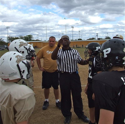 Image: Referee, Robert Hodge, flips the ceremonial coin.
