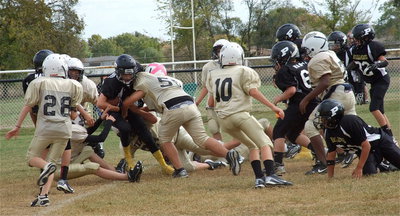 Image: The A-Team Gladiator defense crunches a Palmer runner.